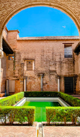 Alcazar Courtyard: Archway and Green Poolの写真素材