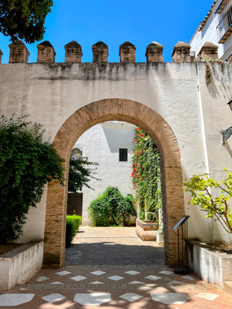 Alcazar Archway Leading to Sunny Courtyardの写真素材