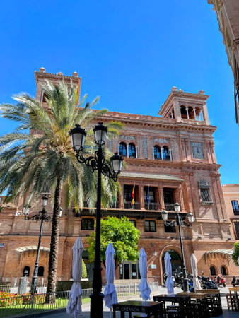 Seville Building with Palm and Streetlightsの写真素材