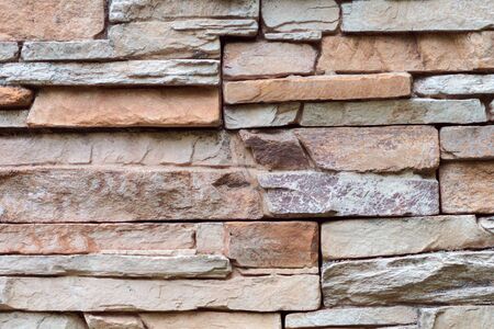 Closeup texture of rough weathered gray brick wall backgroundの写真素材