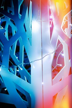 Wooden artificial abstract christmas tree decorated with garlands studio backgroundの写真素材