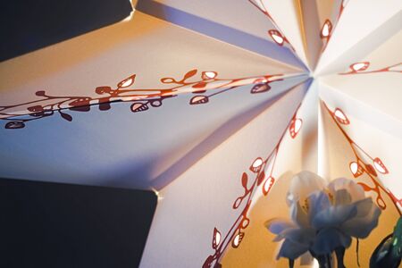 Colored paper star decoration with artificial silk flowers christmas studio backgroundの写真素材