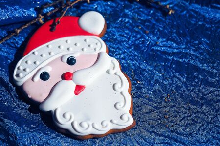 Gingerbread Santa Claus with sweets on table christmas composition backgroundの写真素材