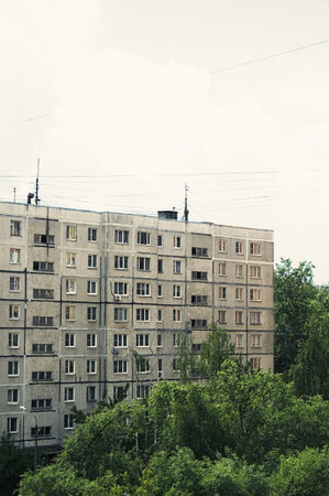 Gray facade of old multi-storey residential building from USSR times in Russia