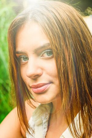 Young attractive brunette dressed skirt and blouse in Moscow summer parkの写真素材