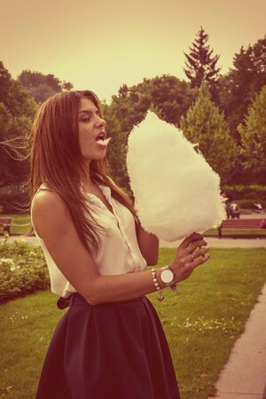 Young attractive brunette dressed skirt and blouse in Moscow summer parkの写真素材
