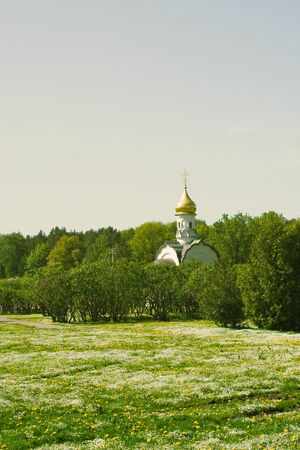 Orthodox white chapel in Moscow park in Russia backgroundの写真素材