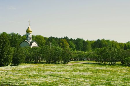Orthodox white chapel in Moscow park in Russia backgroundの写真素材