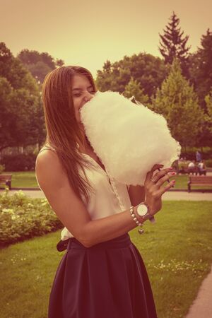 Young attractive brunette dressed skirt and blouse in Moscow summer parkの写真素材