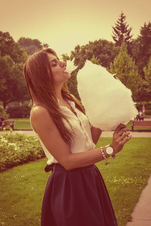 Young attractive brunette dressed skirt and blouse in Moscow summer parkの写真素材