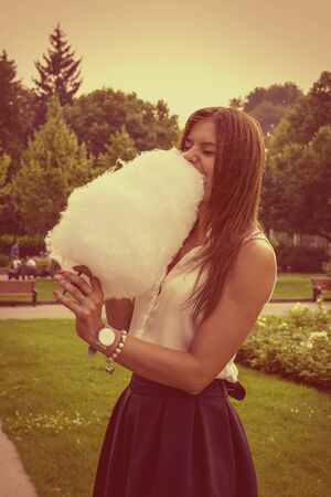 Young attractive brunette dressed skirt and blouse in Moscow summer parkの写真素材