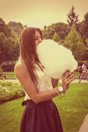 Young attractive brunette dressed skirt and blouse in Moscow summer parkの写真素材