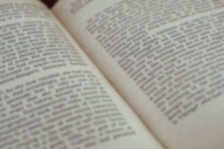 Opened old english book's pages blurred close-up backgroundの写真素材