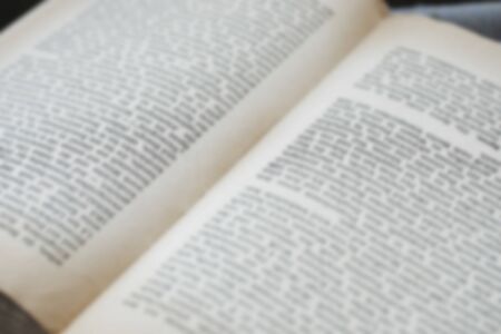 Opened old english book's pages blurred close-up backgroundの写真素材
