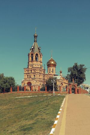 Orthodox red church in park in Russia backgroundの写真素材