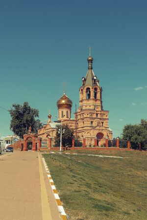 Orthodox red church in park in Russia backgroundの写真素材