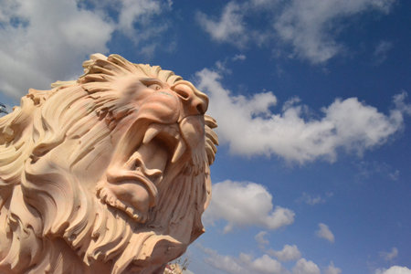 a statue of a lion on a background of the skyの写真素材