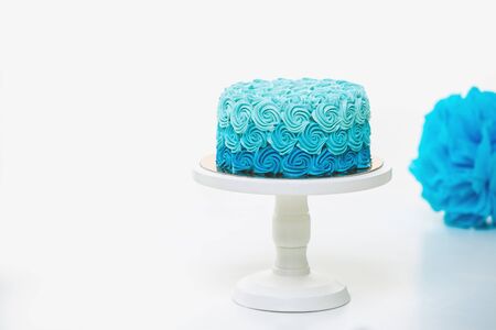 Blue cake and decoration on whte backgroundの写真素材