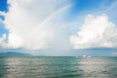 Rainbow over the horizon in the morning the ocean beachの写真素材