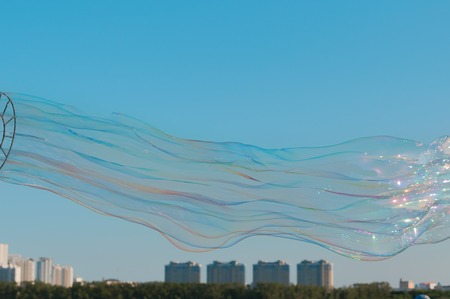 The gigantic soap bubble toy with blue sky backgroundの写真素材