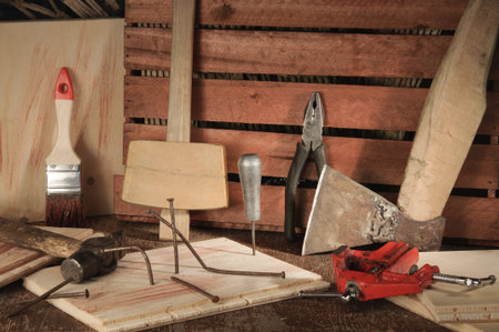 Stylized old tools on wooden table in a joinery.
