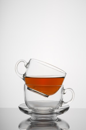 Two transparent glass cup with tea on white backgroundの写真素材