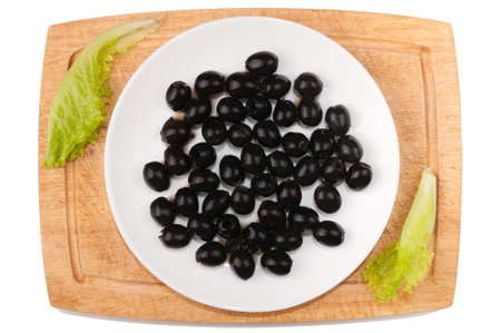 Vegetables on white background. Olives, greens, cutting board, plate on a white background. Vegan. Healthy eating. Cutting vegetables on a board. Cuttingの写真素材