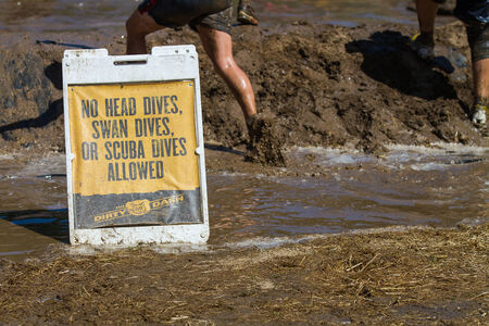 BOISE, IDAHO/USA - AUGUST 10: Safety sign at The Dirty Dash leading up to the mud pit.The event took place  in Boise, Idaho on August 10, 2013 のeditorial素材