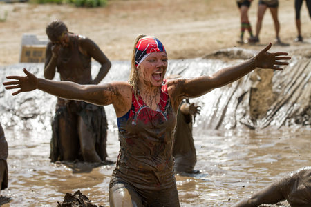 BOISE, IDAHO/USA - AUGUST 11, 2013:Unidentified woman moves with arms spread open at the dirty dash