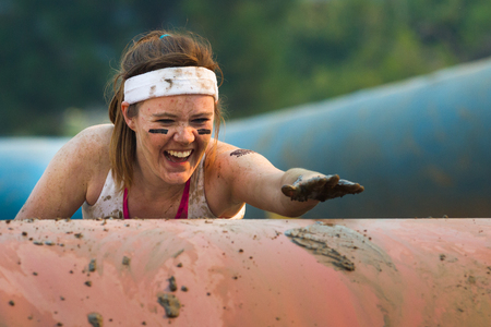 BOISE, IDAHO/USA - AUGUST: Unidentified woman climbs over an obstacle at the The Dirty Dash in Boise, Idaho on August , 2013 のeditorial素材