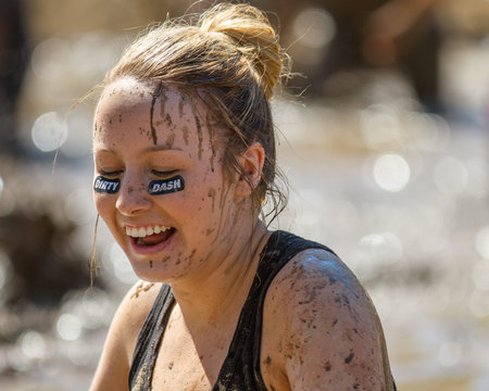 BOISE, IDAHO/USA - AUGUST 10, 2013: Unidentified woman smiles during her run at the The Dirty Dash