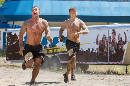 BOISE, IDAHO/USA - AUGUST 10, 2013: Two men run fast to finish the race at the The Dirty Dashのeditorial素材
