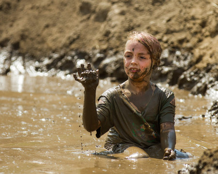 BOISE, IDAHO/USA - AUGUST 11, 2013: Unidentified child plays with the mud at the dirty dash