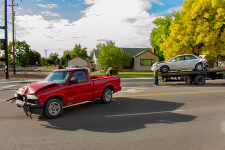 Car on a flat bed while the car that caused the accident is up front