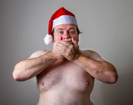 fats santa holding his mouth while looking like he wants to screamの写真素材