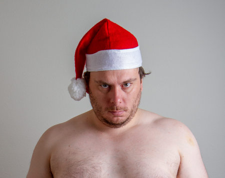 angry looking santa who is not wearing a shirt