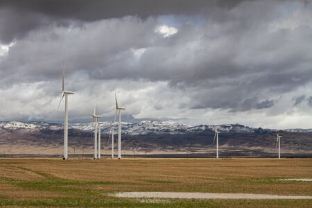 mountains in the background of this wind farmの写真素材