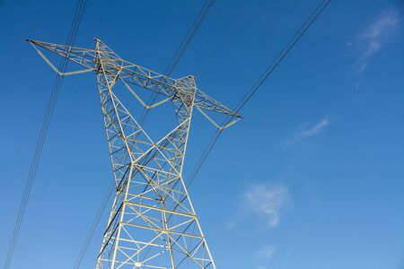 Tall power tower carrying electrical currrent to townの写真素材