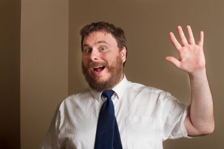 man with a big fake smile waiving at somethingの写真素材