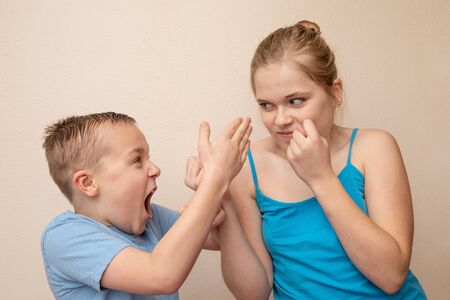 Brother and sister attack and yell at each otherの写真素材