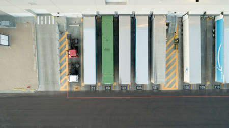 Looking down on trailers unloading goods at the warehouseのeditorial素材