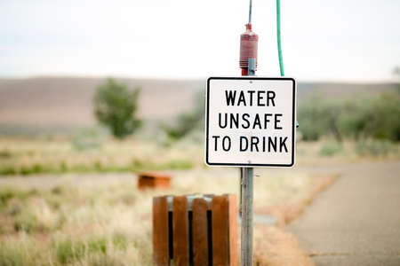 faded water unsafe to drink sign at a camp siteの写真素材