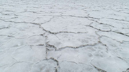 cracks in the ground at the salt flats in utahの写真素材