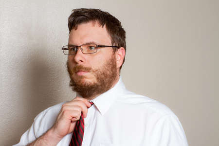 man trying to fix his tieの写真素材