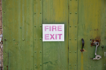 old faded fire exit signの写真素材