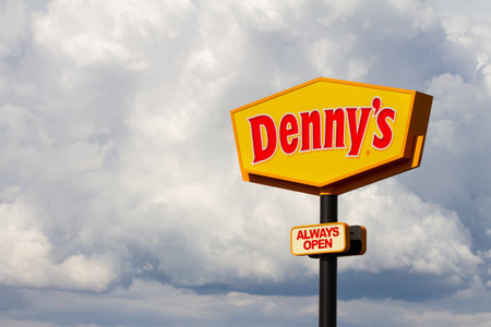 BOISE, IDAHO - MAY 29, 2019 - Dennys restaurant sign with a backdrop of clouds near the Boise Airportのeditorial素材