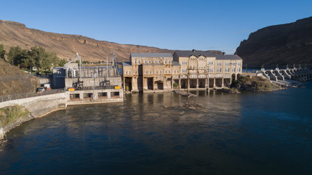 Aerial View of Historic Hydroelectric Power Station by Riverの写真素材