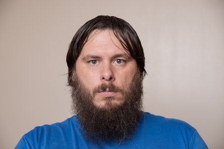 Portrait of a Bearded Man in a Blue Shirtの写真素材