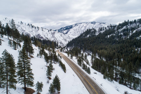 A snowy mountain range with a highway running through it