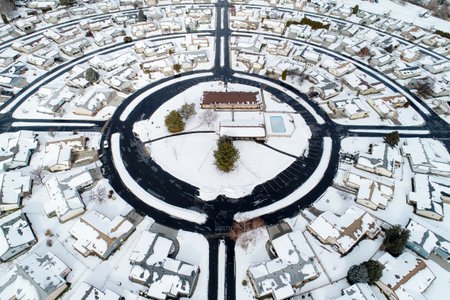 A snow covered neighborhood with a large circle in the middleの写真素材